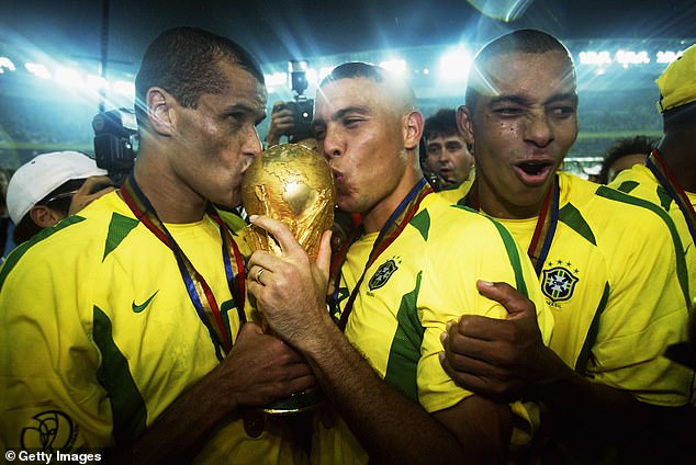Brazil's 2002 team is one of the most legendary World Cup winning teams of all time (Rivaldo and Ronaldo pictured kissing the trophy alongside ex-Arsenal star Gilberto Silva)