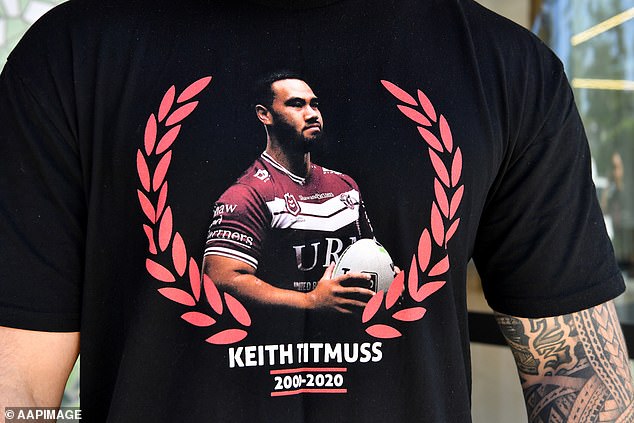 Family and friends wear t-shirts in memory of Keith Titmuss outside Lidcombe Coroners Court