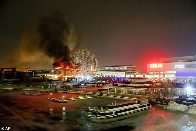 A massive fire is seen above the Crocus City Hall on the western outskirts of Moscow, Russia