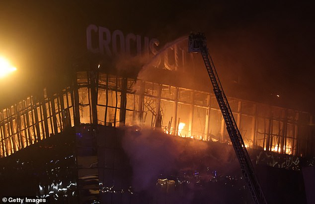 A fire rages inside the Crocus Town Hall in Krasnororsk, Russia