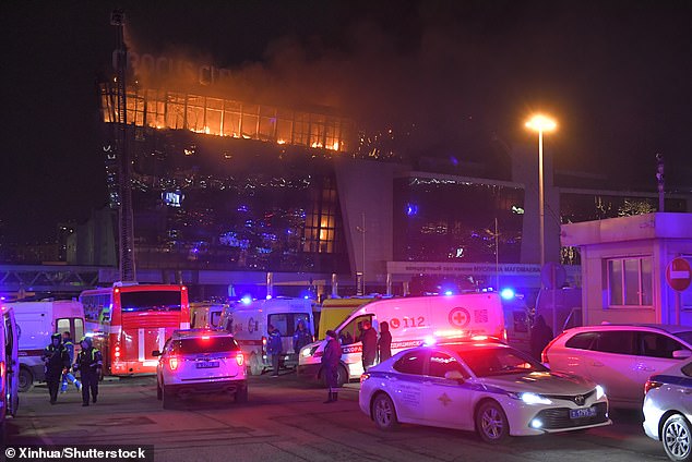 Rescuers work near the burning Crocus City Hall concert venue after the shootings