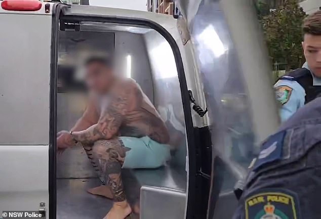 The heavily tattooed man (pictured) was dragged out of an apartment complex in Ryde, in handcuffs wearing nothing but a pair of shorts