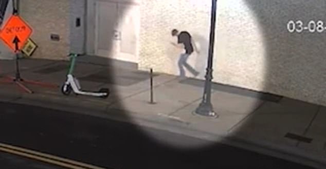 Another camera captured near the intersection of Gay Street and 1st Avenue North just before 1 p.m. 22, while he takes large steps with his head down