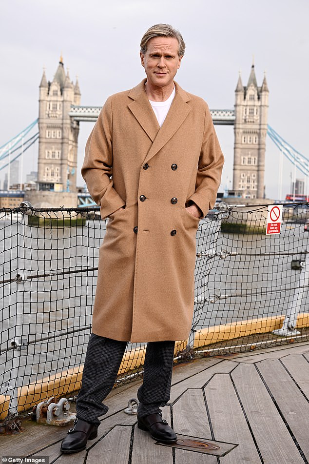 Mission Impossible actor Cary, 61, looked smart in a camel coat and white top teamed with black trousers
