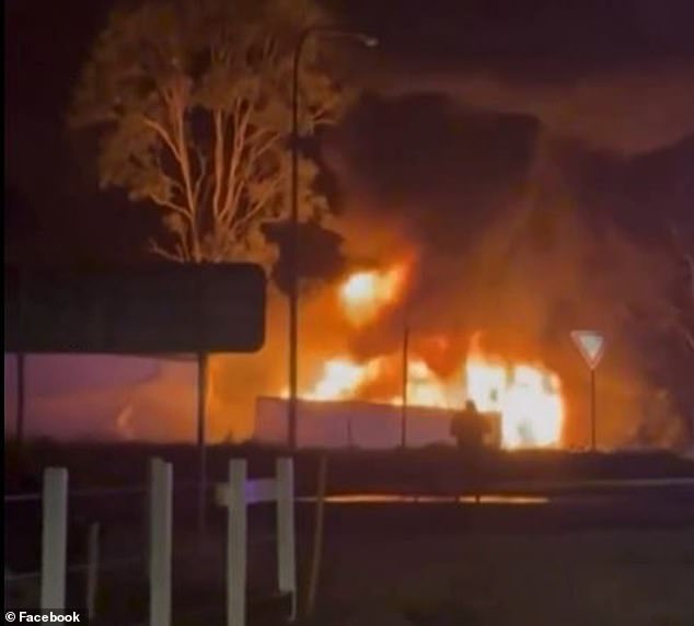 The two trucks burst into flames almost immediately (pictured) after the collision on Friday night