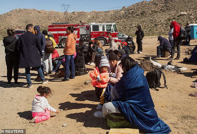 Migrants rest in a temporary camp as they await the opportunity to be processed by the Border Patrol after crossing the Mexican border in an attempt to gain asylum in the United States, in Jacumba, California
