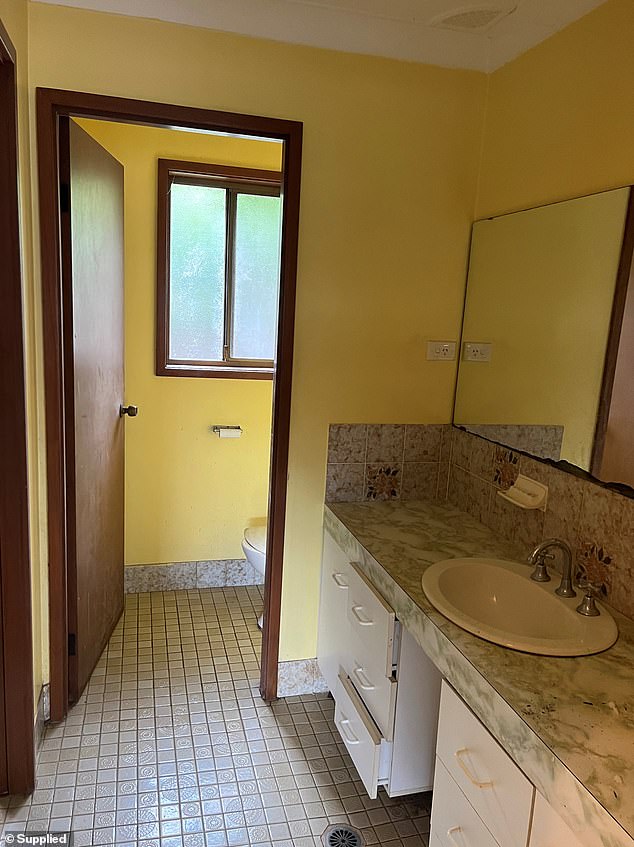 The original bathroom had small tiled, outdated cabinets and yellow walls