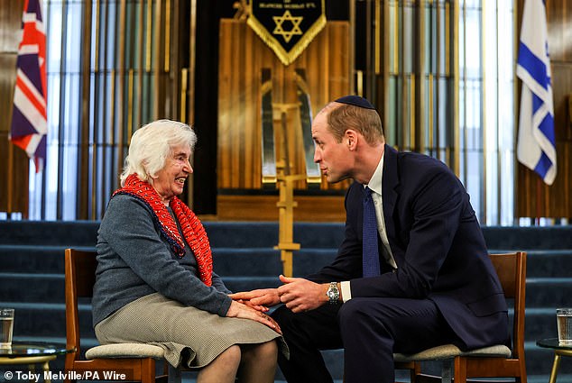 Prince William shakes the hand of Renee Salt, 94, a Holocaust survivor, during a visit to the Western Marble Arch Synagogue in London on February 29