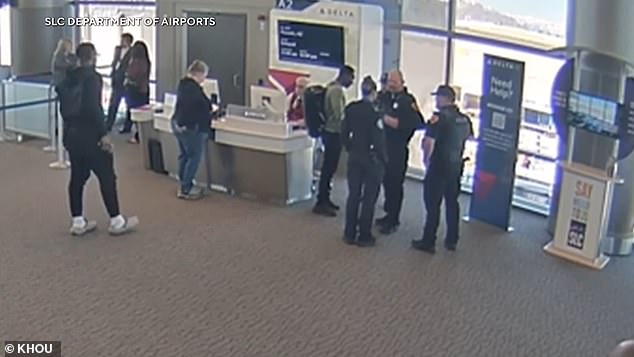 Footage captured the moment the stowaway was questioned by authorities in Salt Lake City and then led away in handcuffs