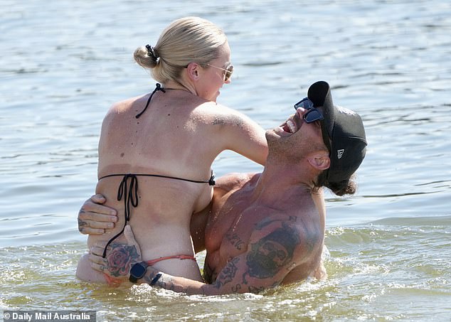 Tori, 27, hugged her man and pulled him close before he picked her up during their ocean swim.