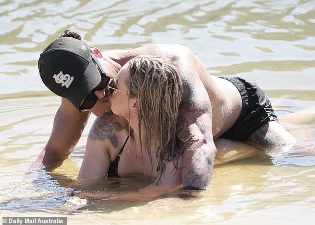 Jack gave Tori a kiss as he lay on top of her as they cooled off on the shore.