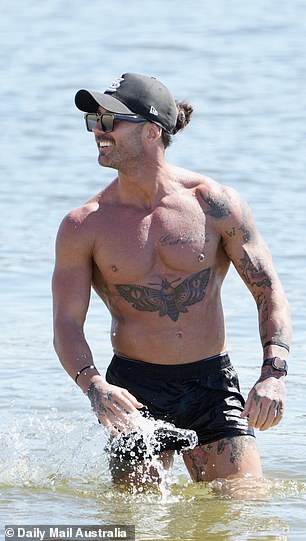 Jack showed off his muscular frame and tattooed figure in a pair of black shorts during the beach outing.
