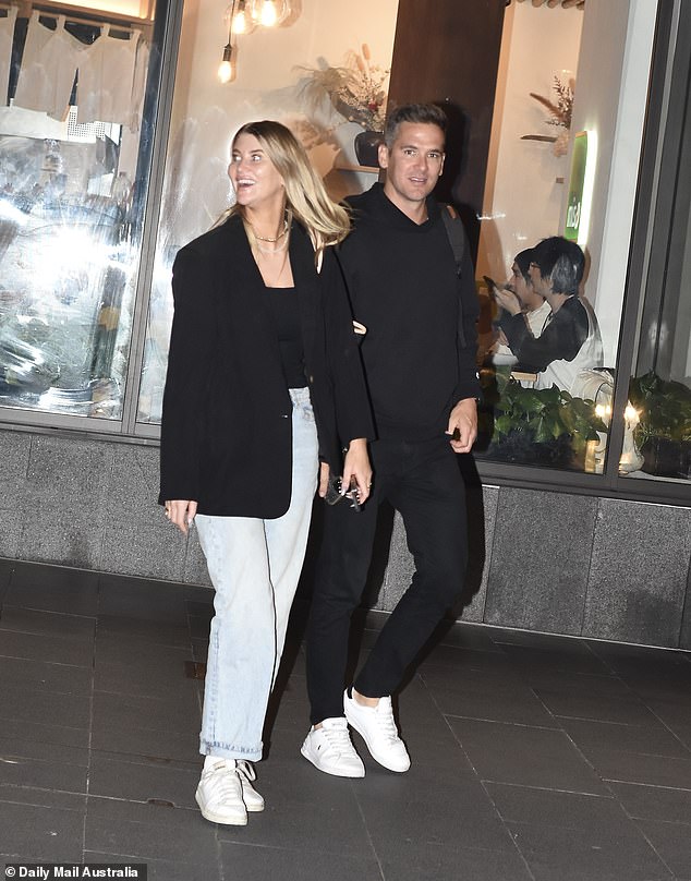 Captured looking relaxed and cheerful as they walked through the city streets, Lauren's laugh seemed to light up the night, and Jonathan matched her bright expression.