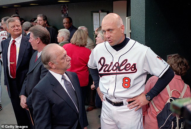 Angelos is pictured with Orioles legend Cal Ripken Jr., who is said to be part of the consortium.