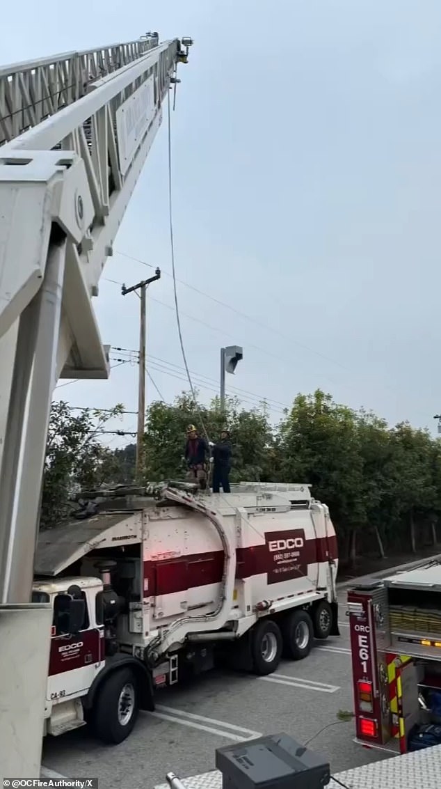 Using ropes and a pulley system attached to a fire truck with a ladder, they removed the woman, who was placed in a fuel basket, from the garbage truck.