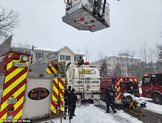 After the woman was rescued from the truck, she was transferred to a stretcher and paramedics and firefighters carried her to an ambulance as flurries of snow fell from the sky.