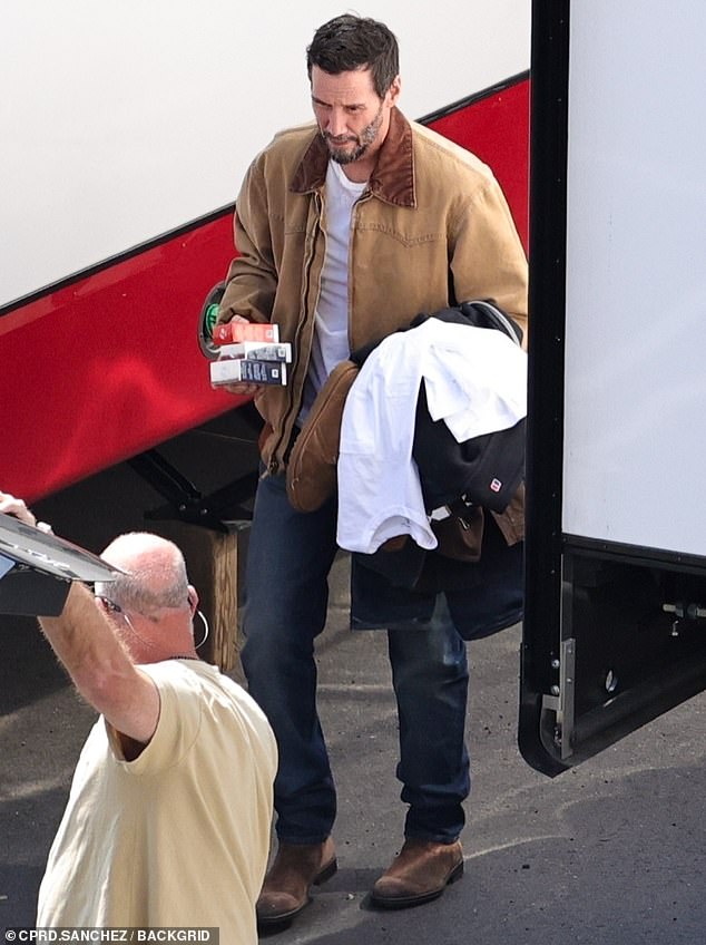 The John Wick franchise star, who will also star alongside Seth Rogen and Aziz Ansari in an upcoming film, looked casual in a two-tone zip-up work coat worn over a white T-shirt.