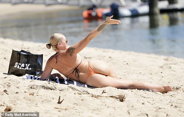 Tori showed off her incredible figure in a tiny orange and black two-piece thong as she lay on a towel and sunbathed, while waving at Jack, who was swimming.