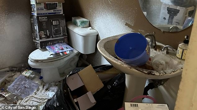 An investigator said he couldn't determine if the house had running water because the sinks and toilets were blocked by so much trash.