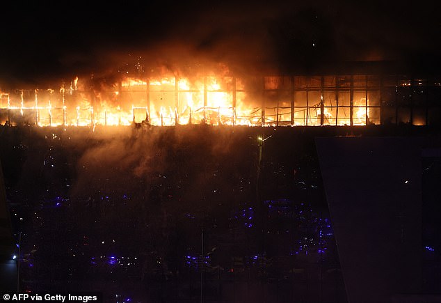 A view shows the Crocus City Hall concert hall on fire following the shooting in Krasnogorsk, outside Moscow.