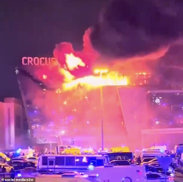An image from last night's scene shows the Crocus City Hall concert venue engulfed in flames as the venue is surrounded by emergency services crews.