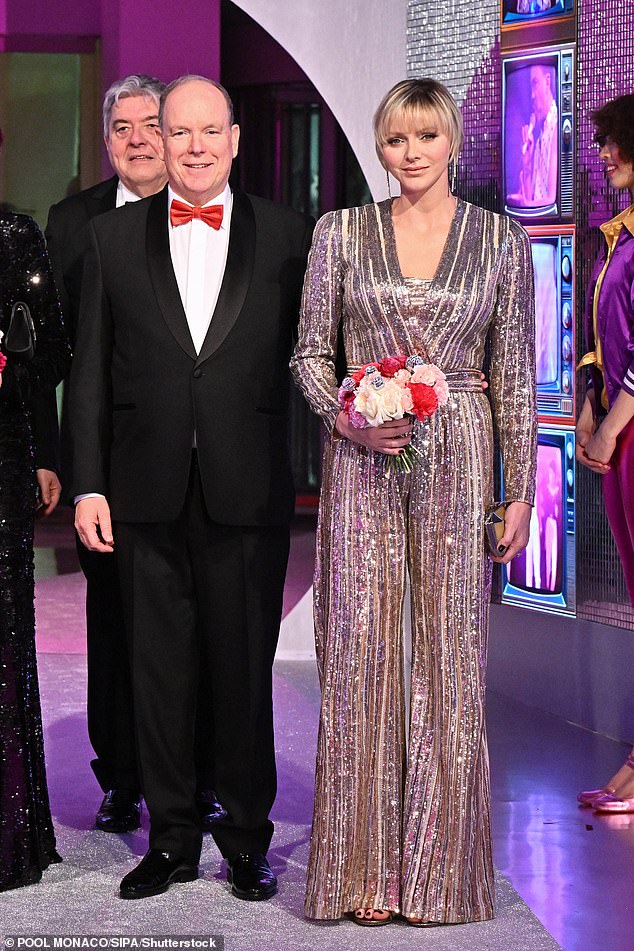 The princess, 46, carried a bouquet of red and pink flowers as she arrived at the 'Disco Bal de la Rose Monaco', presented by Christian Louboutin, with her husband, Prince Albert.