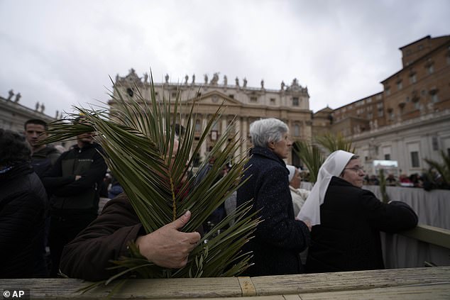 Worshipers gather in St. Peter's Square at the Vatican for the Palm Sunday service