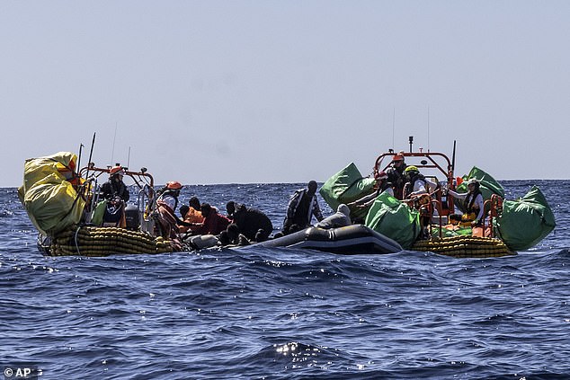 Earlier this month, migrants were helped to evacuate a partially deflated rubber boat. stock image