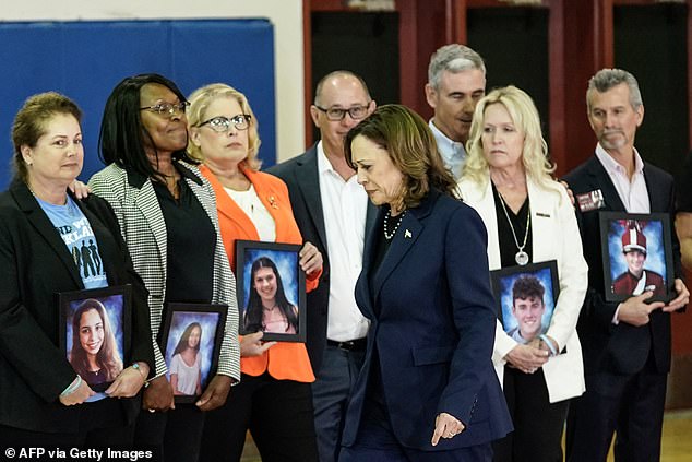 Vice President Kamala Harris walked past grieving parents holding photos of their children to deliver her speech at Marjory Stoneman Douglas High School.