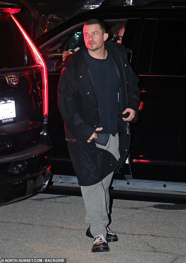 The Red Right Hand action star, 47, who popped the question to the 39-year-old pop star in 2019, wore a black jacket over a matching sweater, gray pants and Doc Marten-style boots.