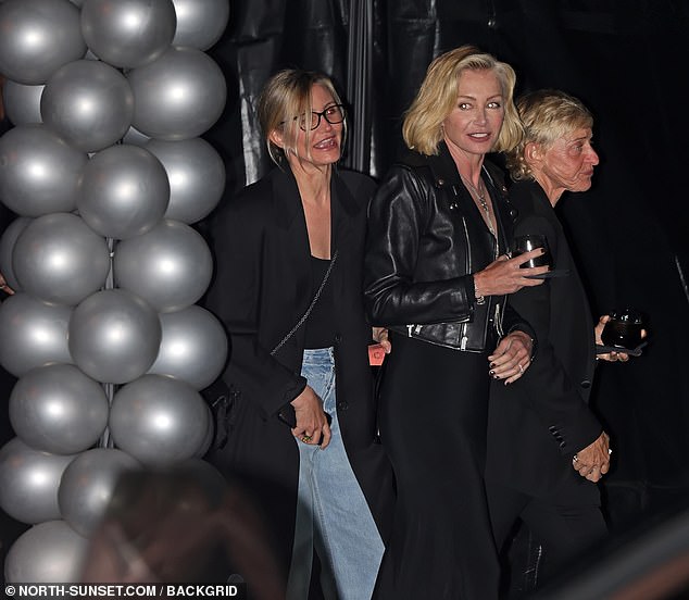 The Avaline co-founder (L), 51, wore a black smock over a matching top and blue jeans while partying with 33-time Daytime Emmy Award winner Ellen DeGeneres (R) and her wife Portia de Rossi (m).