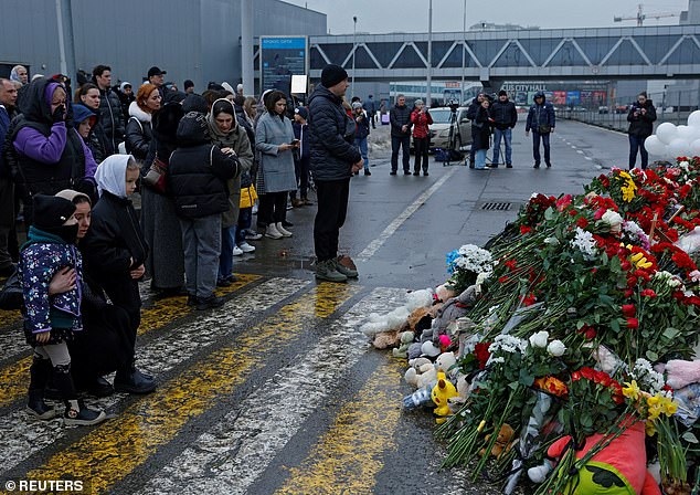 People gather at a makeshift memorial to victims of a shooting attack set up outside the Crocus City Hall concert hall in Moscow region, Russia, on March 24.