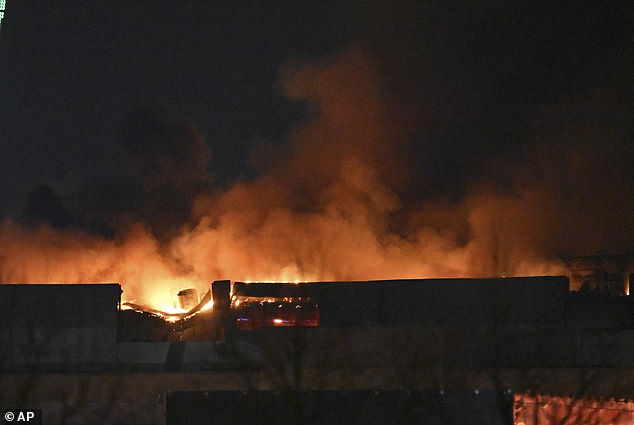 A massive fire is seen above Crocus Town Hall in Moscow's western edge on Friday after ISIS gunmen stormed the site and killed at least 143 people.