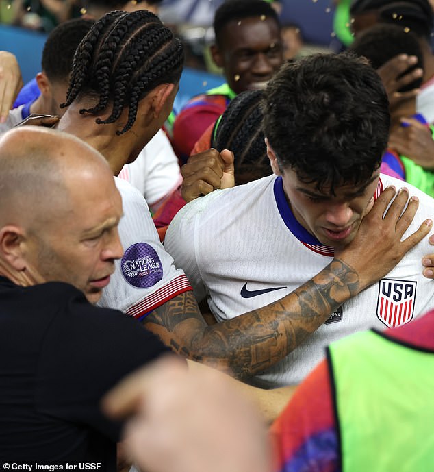 Berhalter, whose expulsion of Reyna in the World Cup caused a scandal, hugs the player