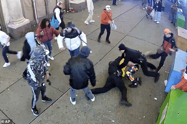 Surveillance footage shows a fight between NYPD officers and immigrants in Times Square in February