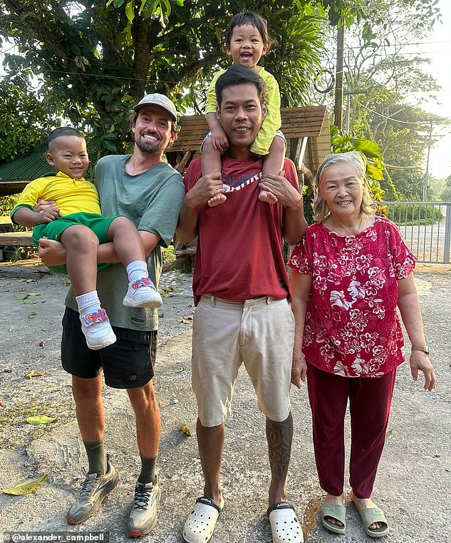 Alexander stayed in cheap accommodation, pitched a tent, and stayed with locals throughout his journey. Here he is pictured with a family who hosted him in southern Thailand.