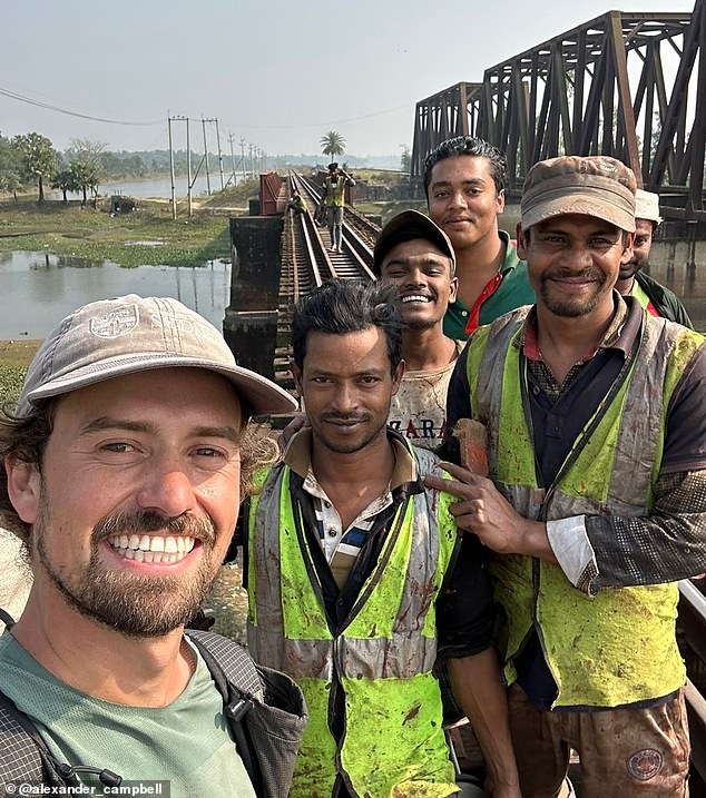 Alexander is pictured above with a group of workers repairing a railway bridge in Bangladesh.
