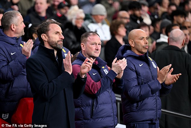 Meanwhile, England manager Gareth Southgate (left) has denied that White's alleged clash with Steve Holland (centre) is the reason for his unavailability.