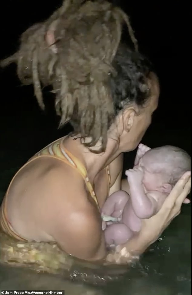 Josy filmed a 'very special' ocean birth video, cradling her newborn while still in the ocean (pictured)