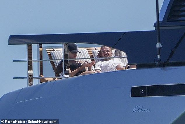 David wore a white t-shirt as he relaxed on board the luxury boat.