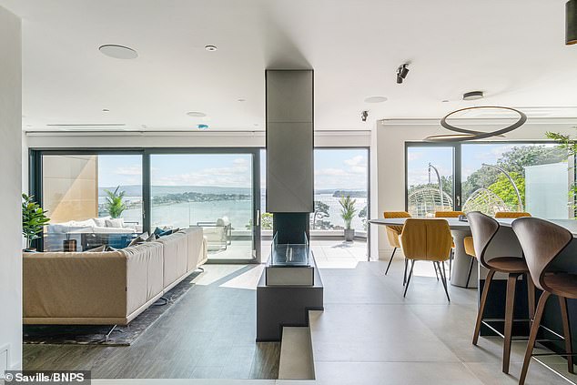 There is an open plan living area with a kitchen/diner and sunken lounge, both with doors leading out to the balcony which extends the full width of the building.