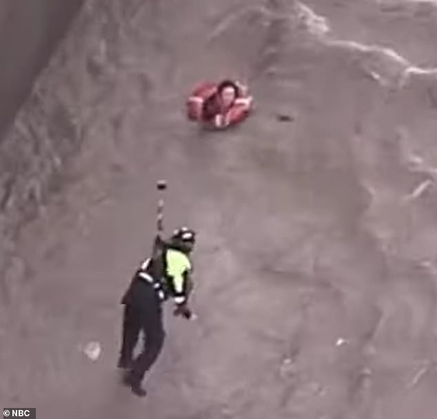 The woman lunged toward the lifeguard, who prepared to try to pull the woman out of the river.