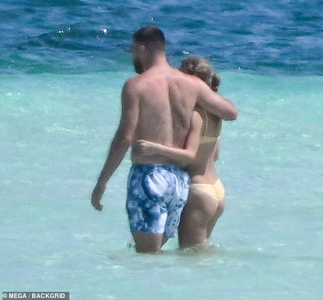The Kansas City Chiefs tight end put his arm around his girlfriend, who was showing off her peachy butt.
