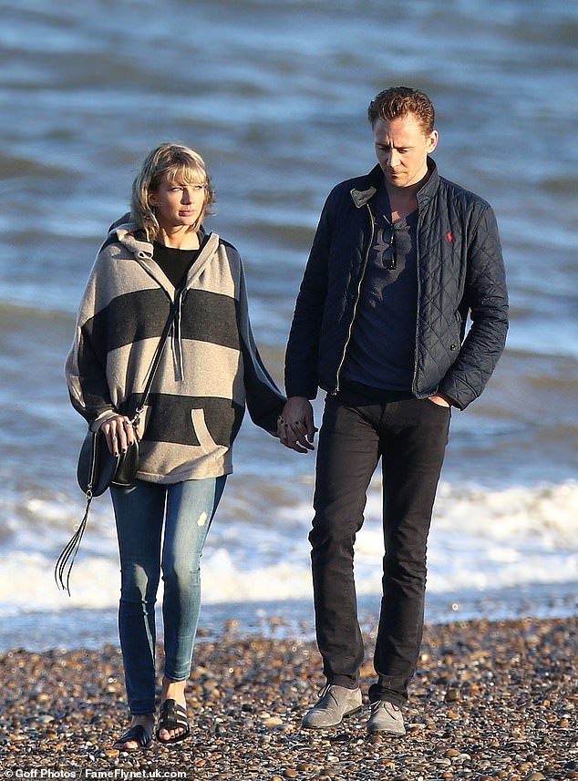 Taylor is seen enjoying a walk on the beach with her then-boyfriend Tom Hiddleston in 2016.