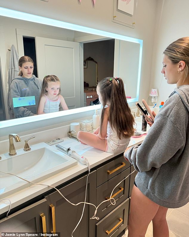 Britney Spears' younger sister, 32, posted a photo of Ivey sitting patiently while her older sister, Maddie, 15, curled her hair.