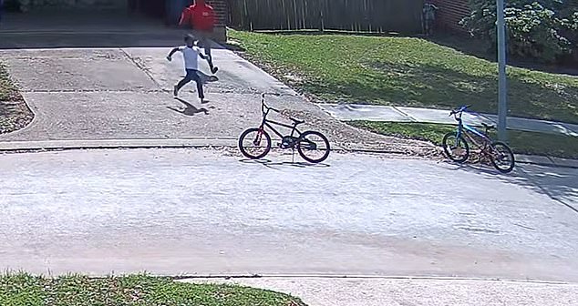 Seconds later, the boys ran out of the garage, got on their bikes and rode away from the scene.