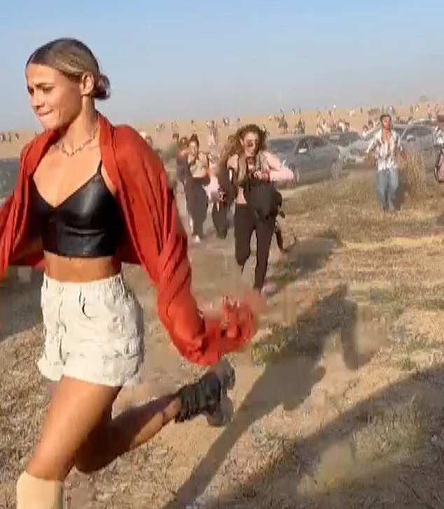 People are seen fleeing a music festival after the Hamas attack in Israel on October 7 last year.