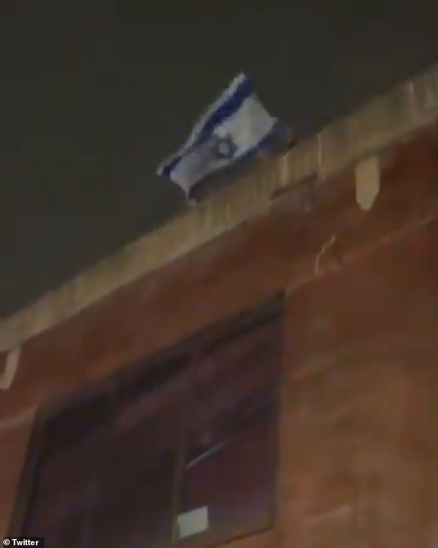 John Fetterman trolls pro-Palestinian protesters by waving a huge Israeli flag at the mob that shows up at his Pennsylvania home.
