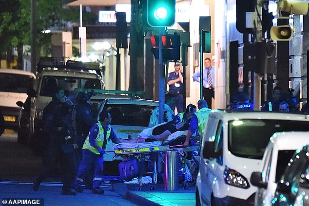 Of the 18 hostages in the cafe, Manis shot and killed Tori Johnson, 34, and Katrina Dawson, 38, was killed by police bullet fragments (pictured, paramedics tending to the wounded at the end of the siege)