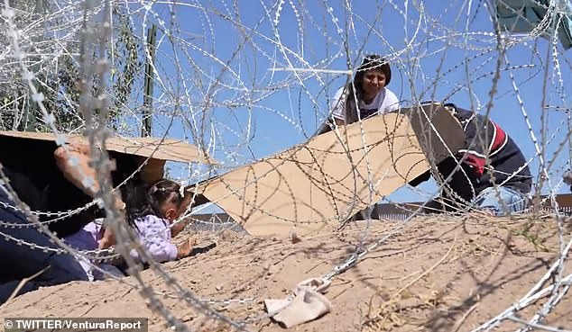 A group of Venezuelans wore cardboard on their backs to avoid being cut as they crawled under a barbed wire barrier set up to prevent migrants from entering El Paso, Texas.